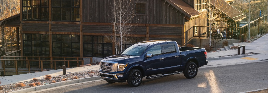 2021 Nissan TITAN parked in front of a large wood house