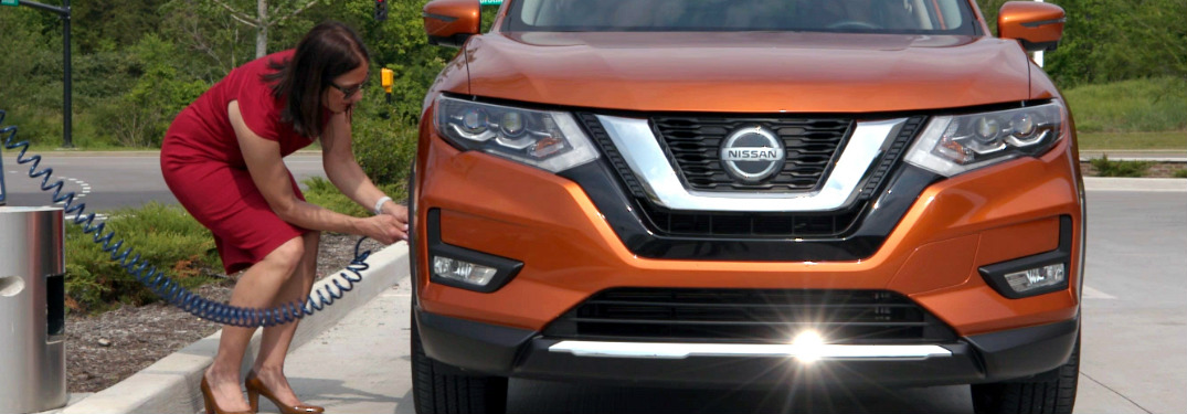 Woman using the Nissan Easy-Fill Tire Alert system to add air to her tires