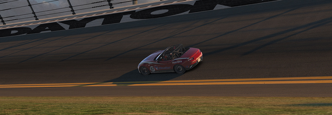 Red Mazda MX-5 Race Car Driving on a Race Track