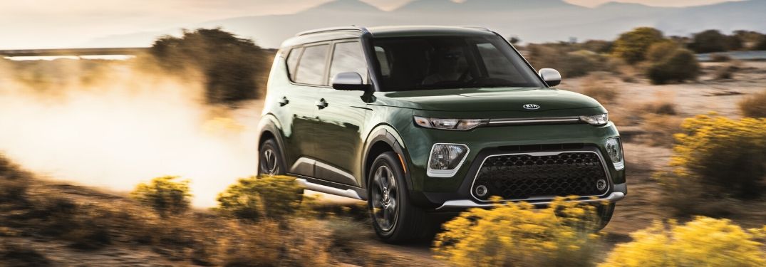 2020 Kia Soul driving down dirt road from exterior front passenger side