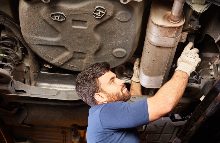 Mechanic working on exhaust
