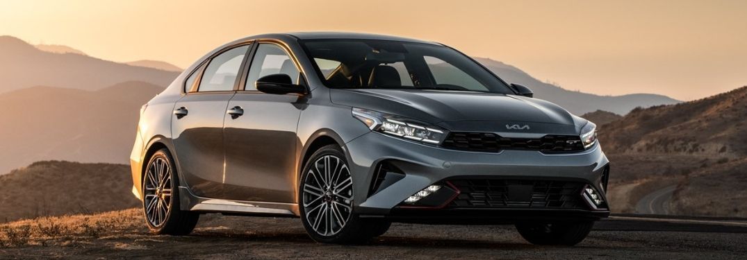 The all-new 2022 Kia Forte backdropped by an evening landscape