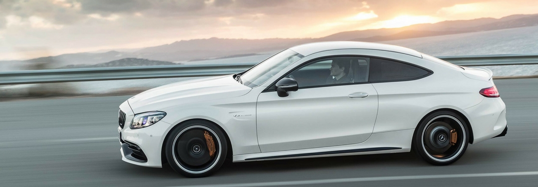 mercedes-amg c 63 driving at sunset full view