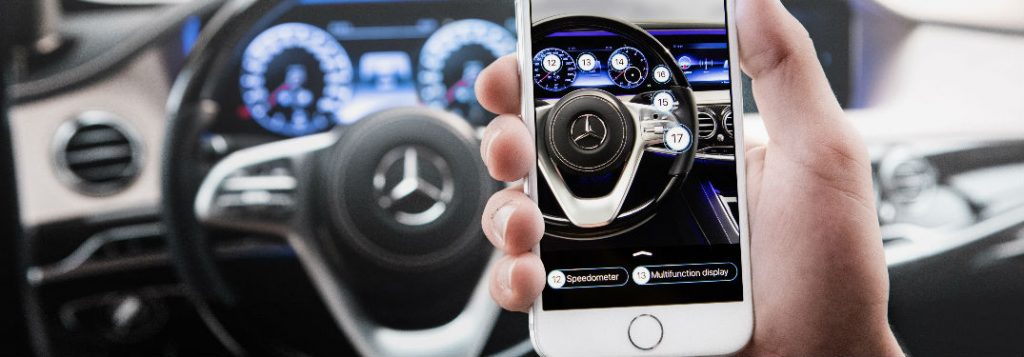 hand holding smartphone using mercedes-me app