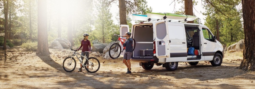 Mercedes-Benz van with bikes and people