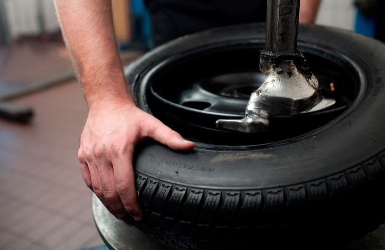 hands holding a black tire