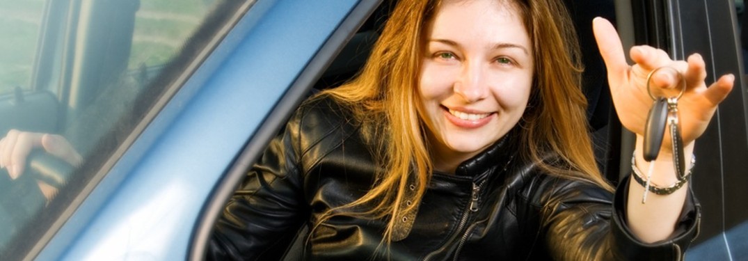 a woman in a car holding car keys