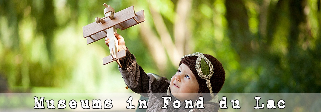 Boy playing with a vintage toy plane museums in Fond du Lac