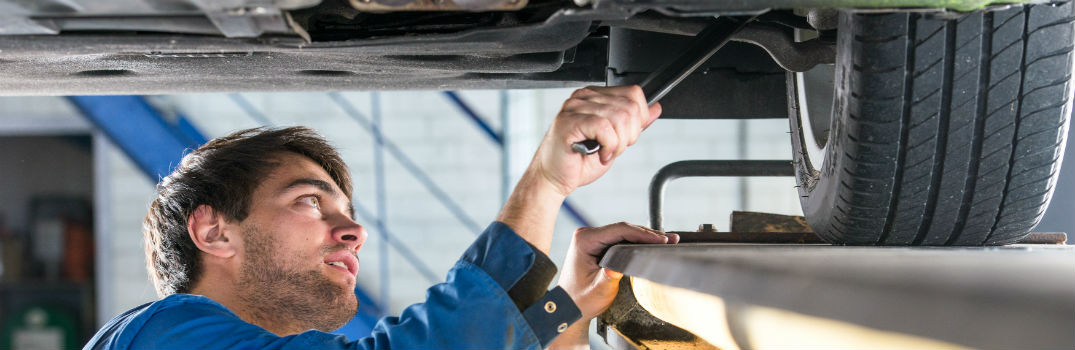 mechanic aligning wheels