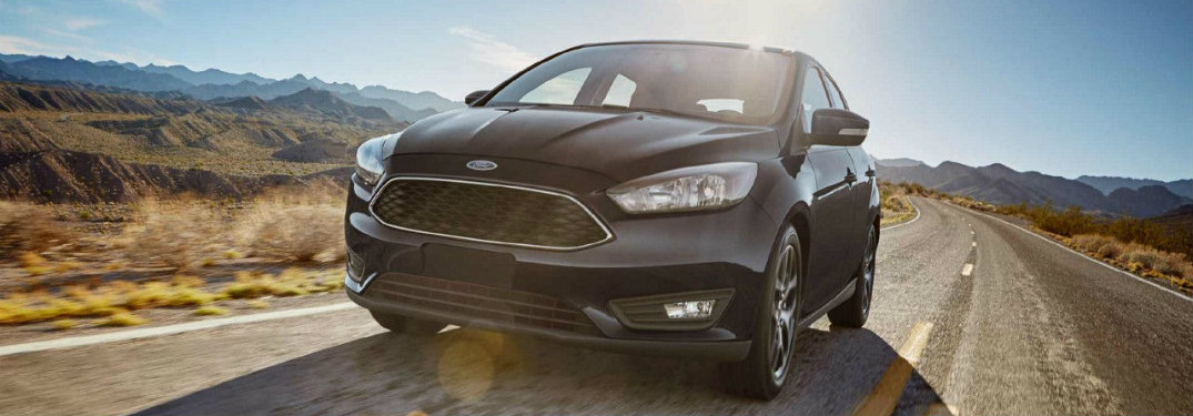 Black-2018-Ford-Focus-driving-on-highway-in-front-of-mountains