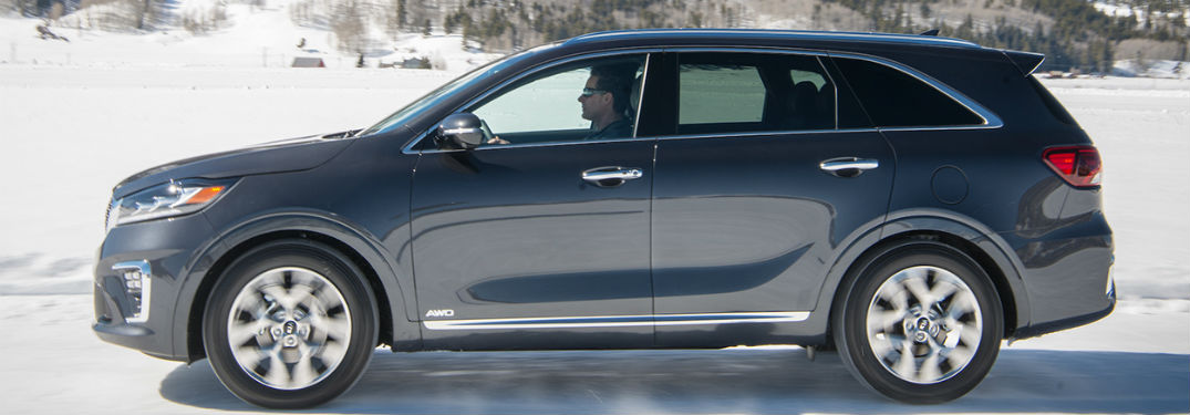 2019 Kia Sorento exterior drivers side profile going fast in snow with man driving