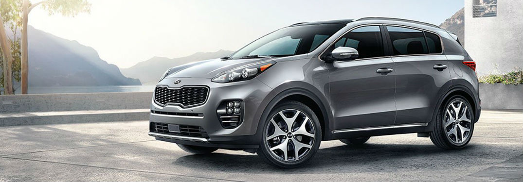 2018 Kia Sportage exterior front fascia and drivers side on tiled lot with building