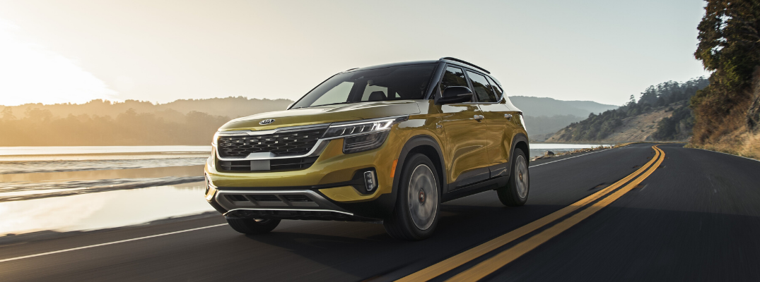 Front view of yellow 2021 Kia Seltos on the road