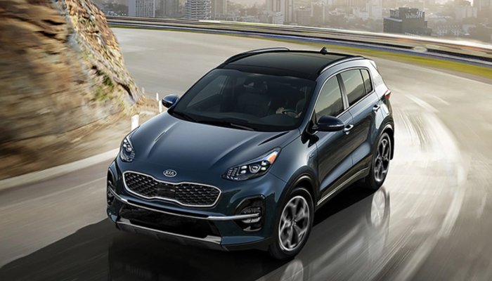 2020 Kia Sportage driving down a curved road