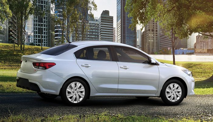 2020 Kia Rio driving down a path