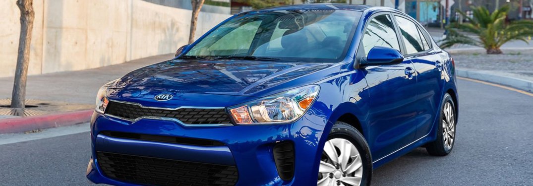 2020 Kia Rio driving down a city street