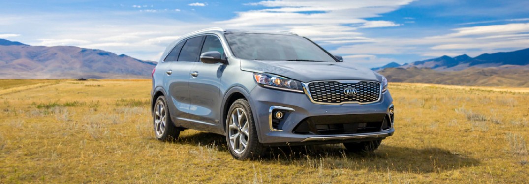 2020 Kia Sorento light paint parked on grassy hill with mountains in background