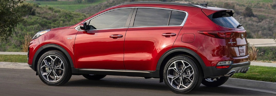 2020 Kia Sportage Red paint driving down road trails in background