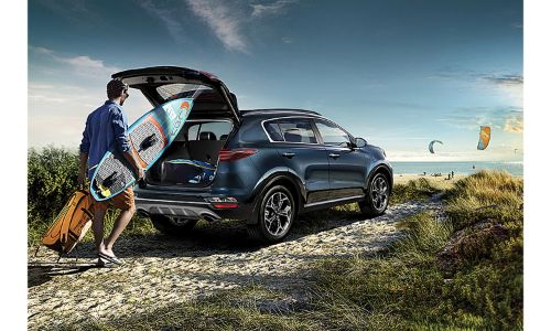 2020 Kia Sportage parked by beach surfboards unloading