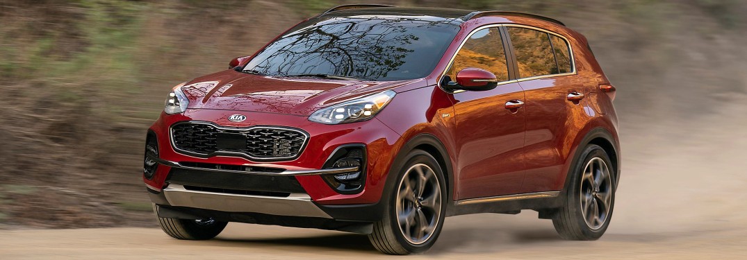 2022 Kia Sportage red driving on dusty road