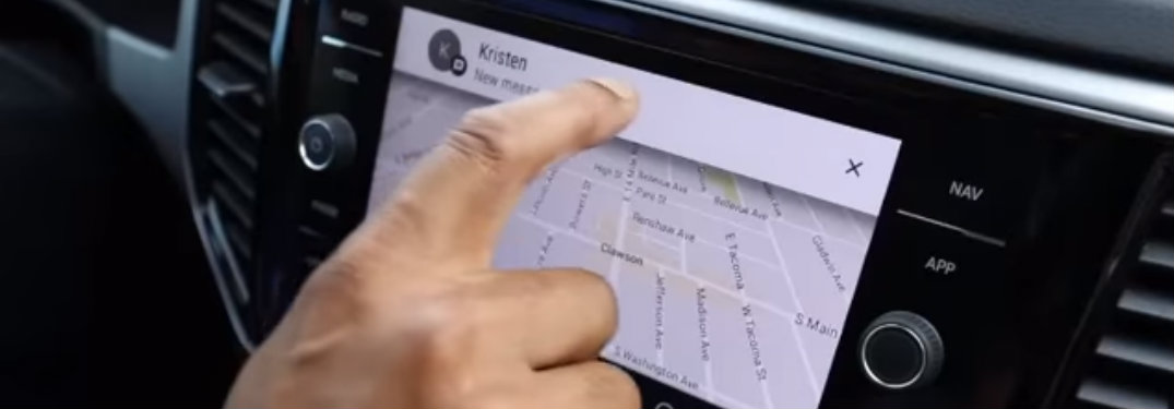 Hand pressing incoming text banner on VW infotainment