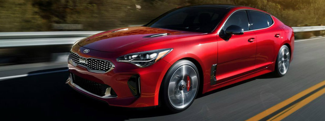 Red 2018 Kia Stinger cruising on a highway