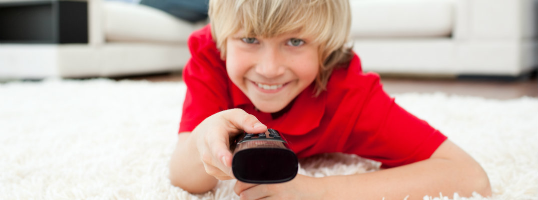 Little boy with a TV remote