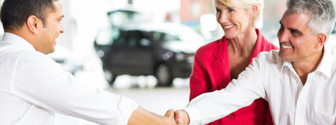 Customers working out a trade agreement with a dealership