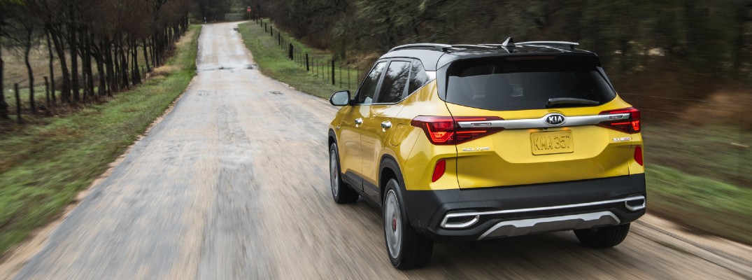 2021 Kia Seltos yellow exterior rear driving down country road