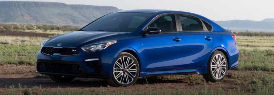 2020 Kia Forte blue exterior front driver side parked in field