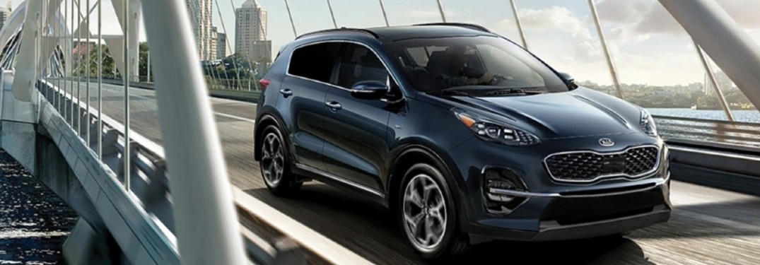 2021 Kia Sportage blue exterior front fascia passenger side driving on bridge