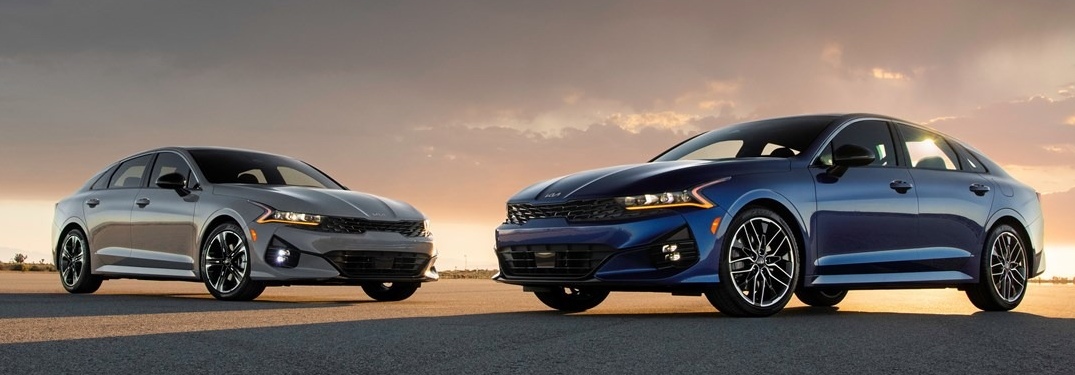 Two 2022 Kia K5 sedans with sunset in the background