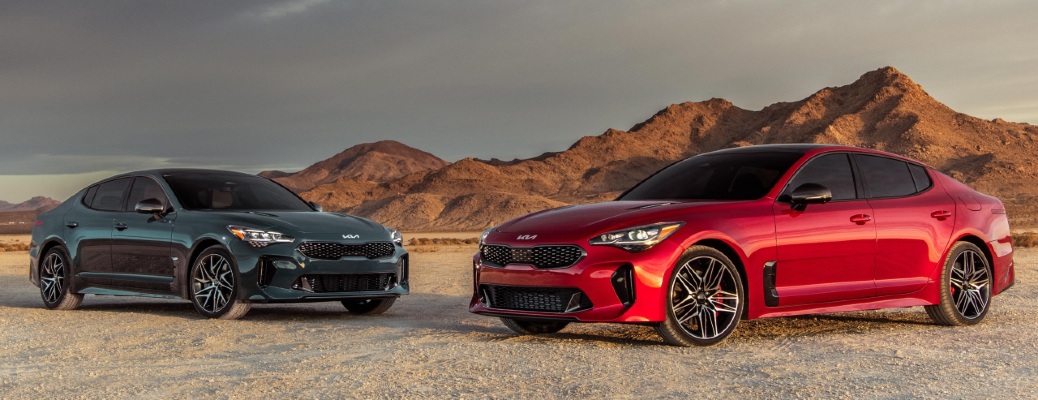 two kia stingers in the desert