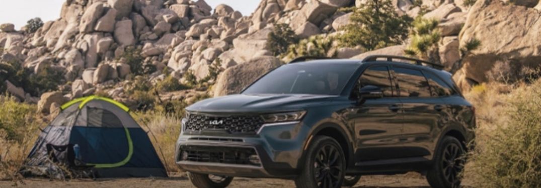 2022 Kia Sorento standing in a forest near a tent