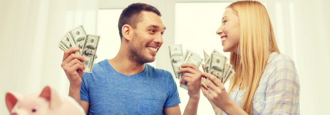 young man and woman holding money