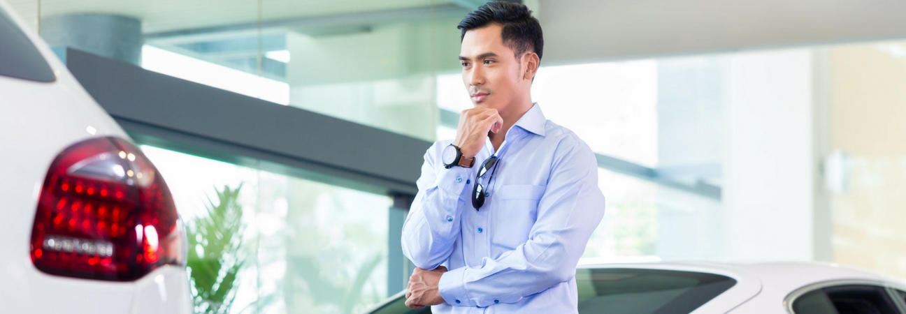 A man looking at a car featured in a blog post about car shopping