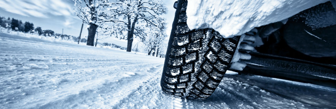 Snowy Car Tires on Winter Road