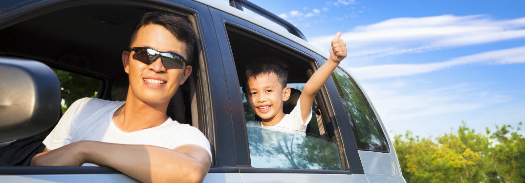 dad driving son in a car
