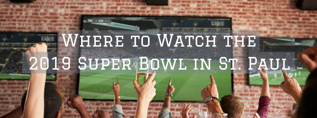 Hands cheering in front of football on tv screen with Where to Watch the 2019 Super Bowl in St. Paul white text