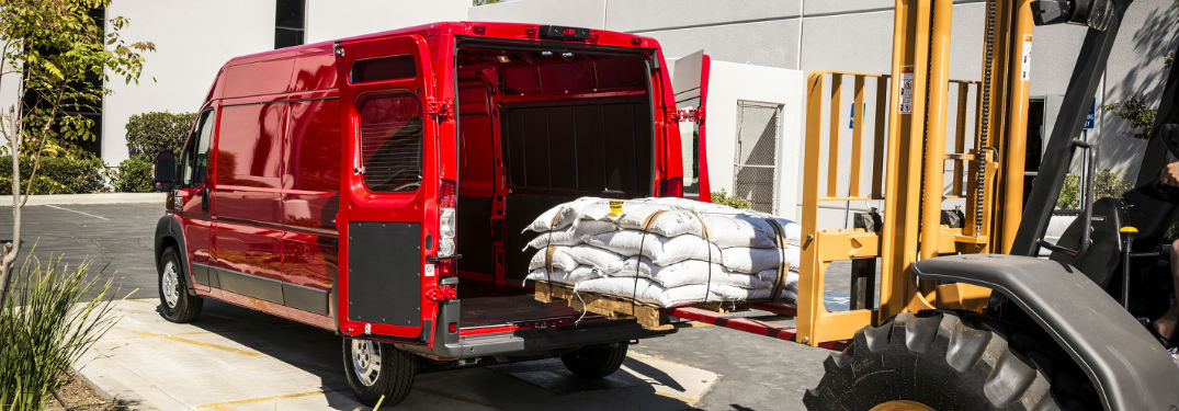 red 2018 Ram ProMaster cargo van being loaded with supplies