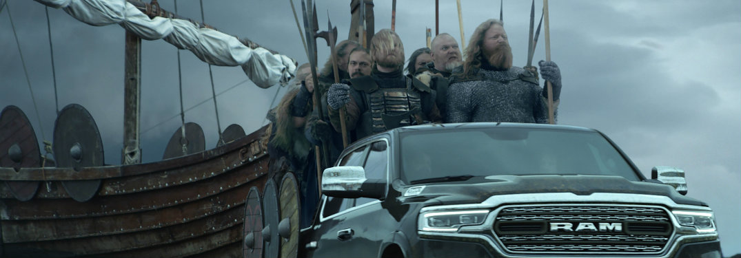 Icelandic Vikings riding a Ram truck with their ship in the background in Ram Super Bowl 52 commercial