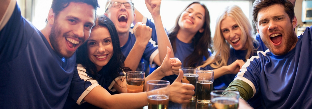 group of people watching sports at a bar