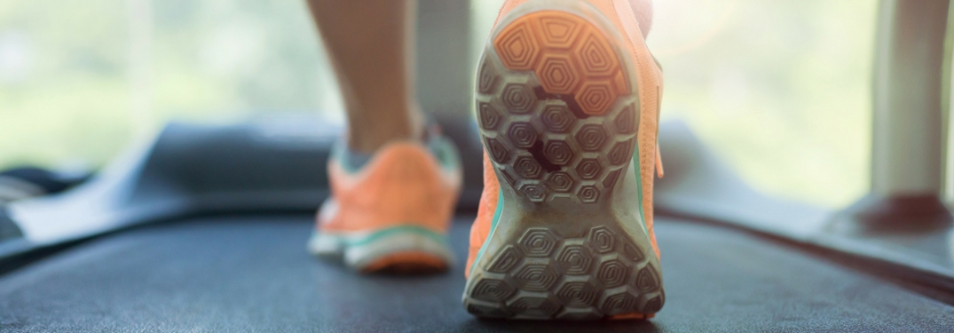feet running on a treadmill