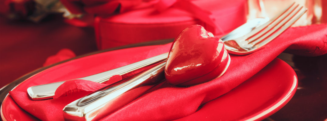 Valentine's Day dinner with red plate, knife, fork, and napkin in a restaurant