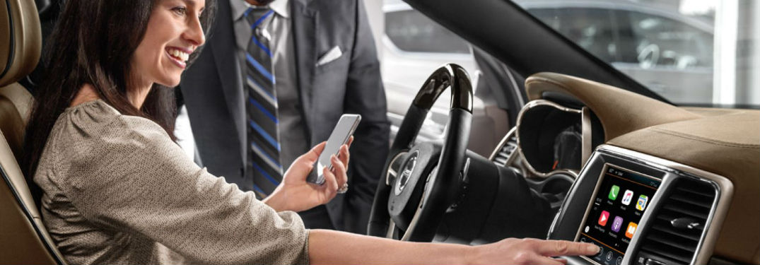 woman syncing iPhone to Uconnect® system