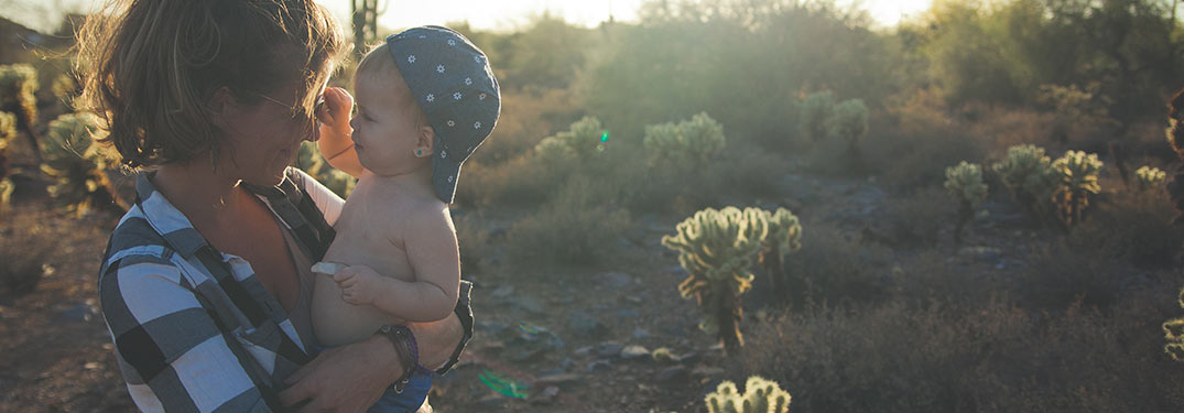 Mother holding her son in the desert