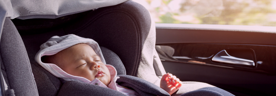 baby sleeping in a car seat