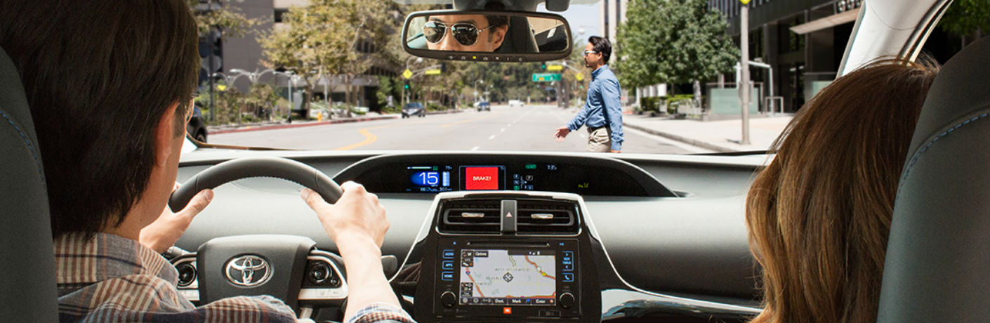Toyota driver alerted to a pedestrian via Toyota Safety Sense on their dashboard
