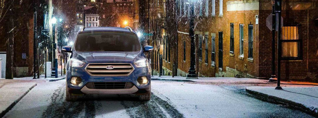 2018 Ford Escape driving up snowy path at night