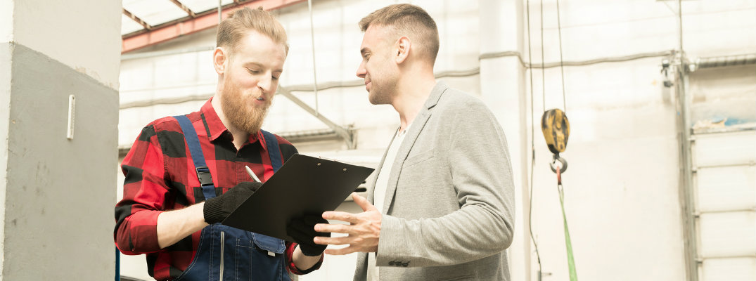 Mechanic taking automotive customer through auto checklist